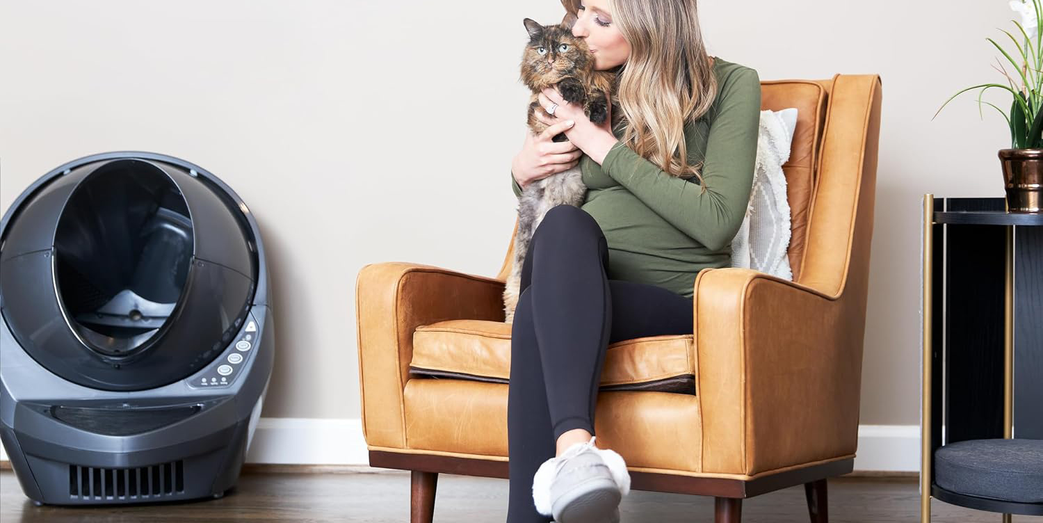 A woman sitting in a chair holding a cat