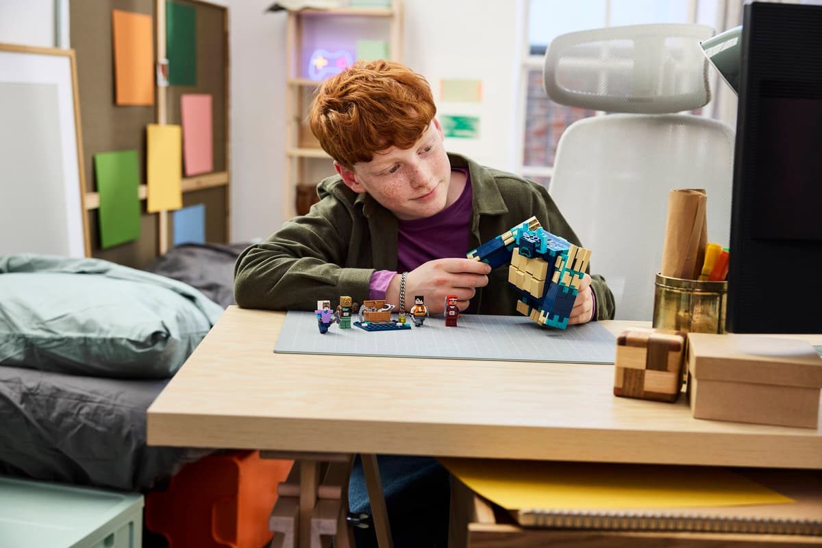 A boy playing with lego blocks