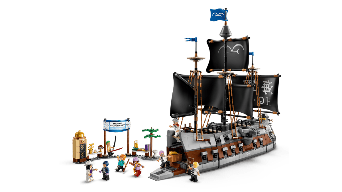 A toy pirate ship with people standing around