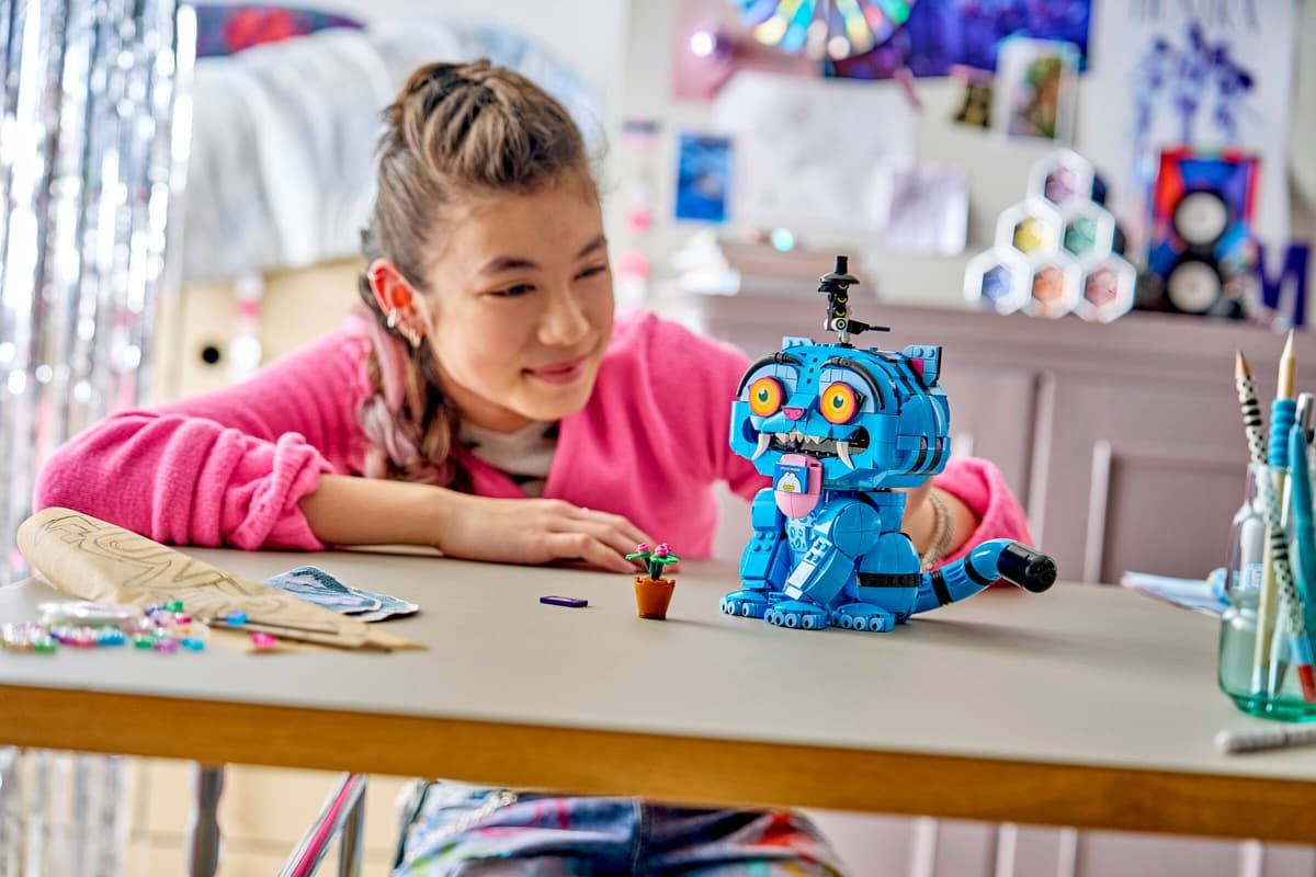 A girl looking at a toy