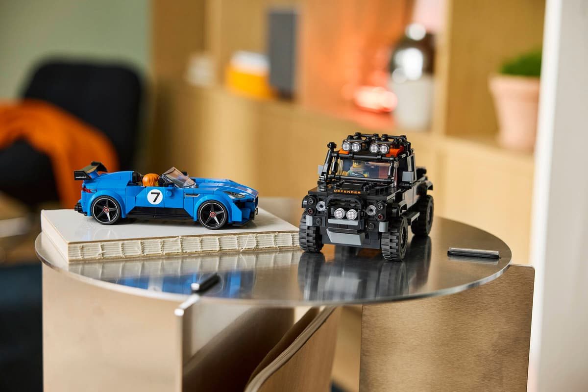 A toy car and a car on a table