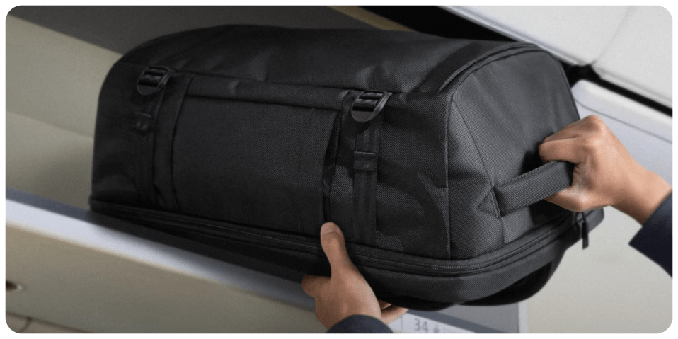 A person holding a black bag