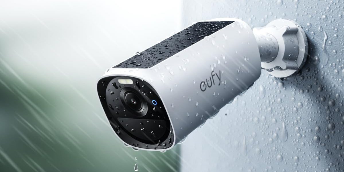 A white and black camera with water droplets on it