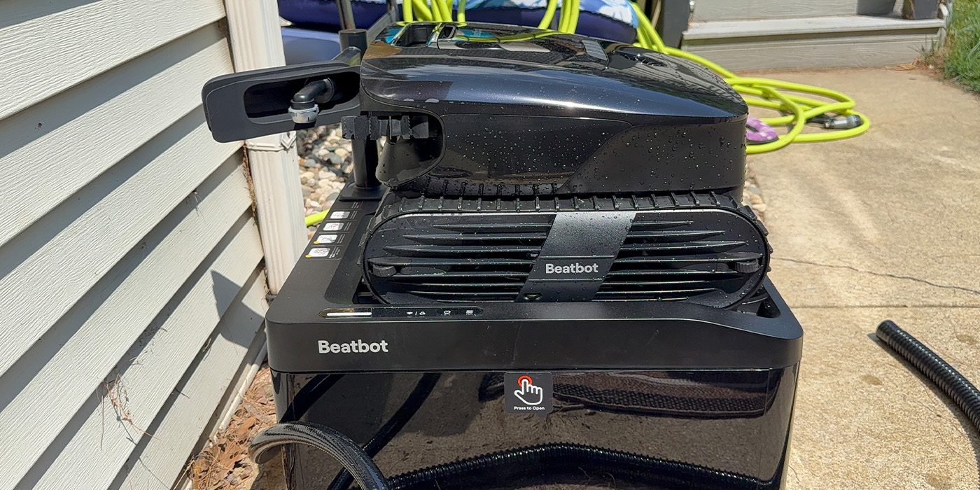 A black machine with a hose attached to it