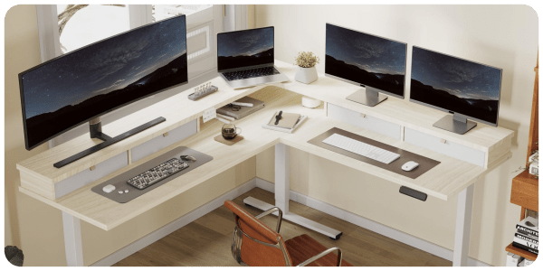 A desk with computers and a laptop
