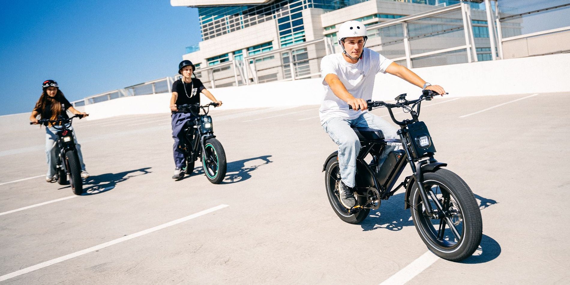 Two people riding motorcycles in a parking lot