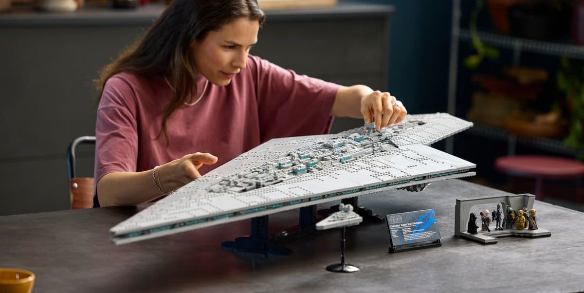 A woman playing with a model of a spaceship