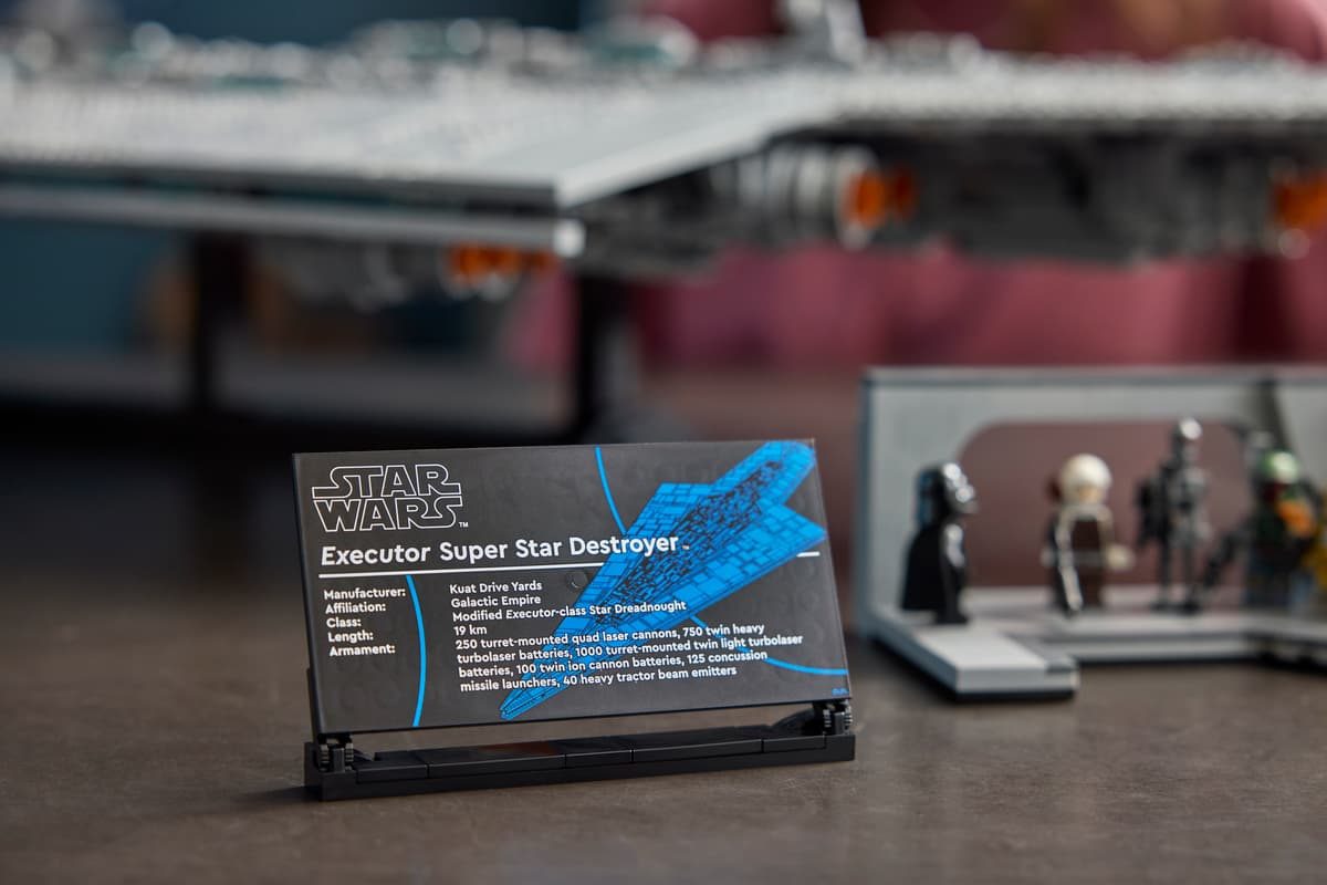 A sign next to a toy model of a spaceship