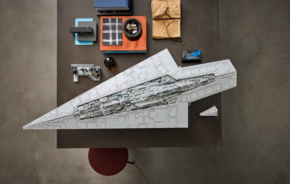 A model of a spaceship on a table with many objects around it