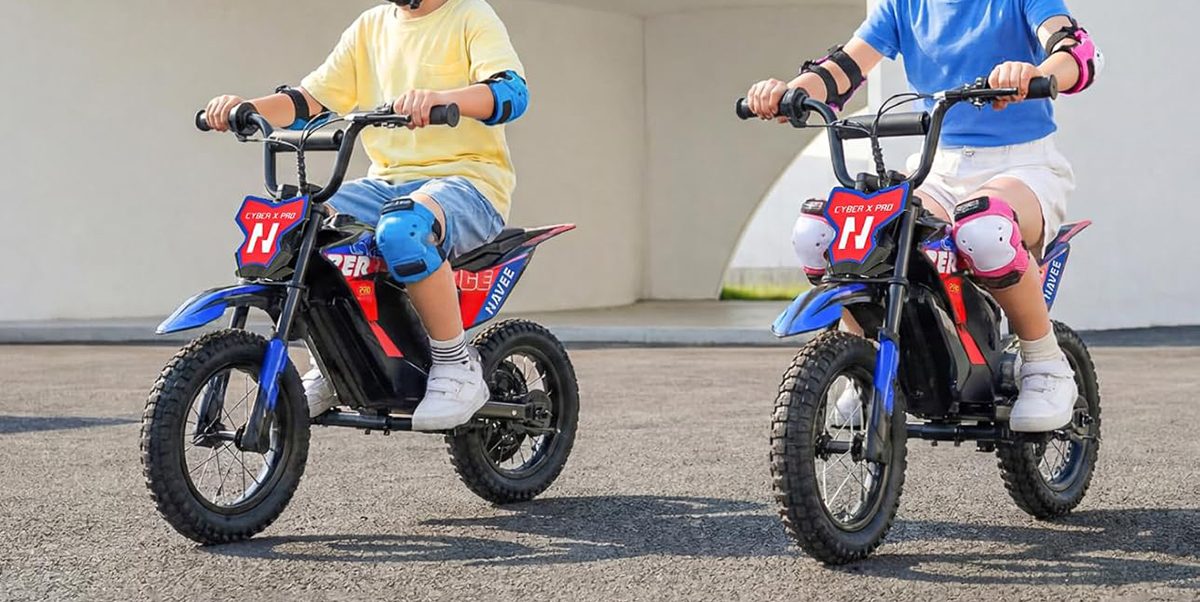 Two kids riding on small motorcycles