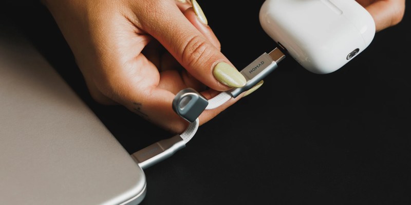 A hand holding a cable
