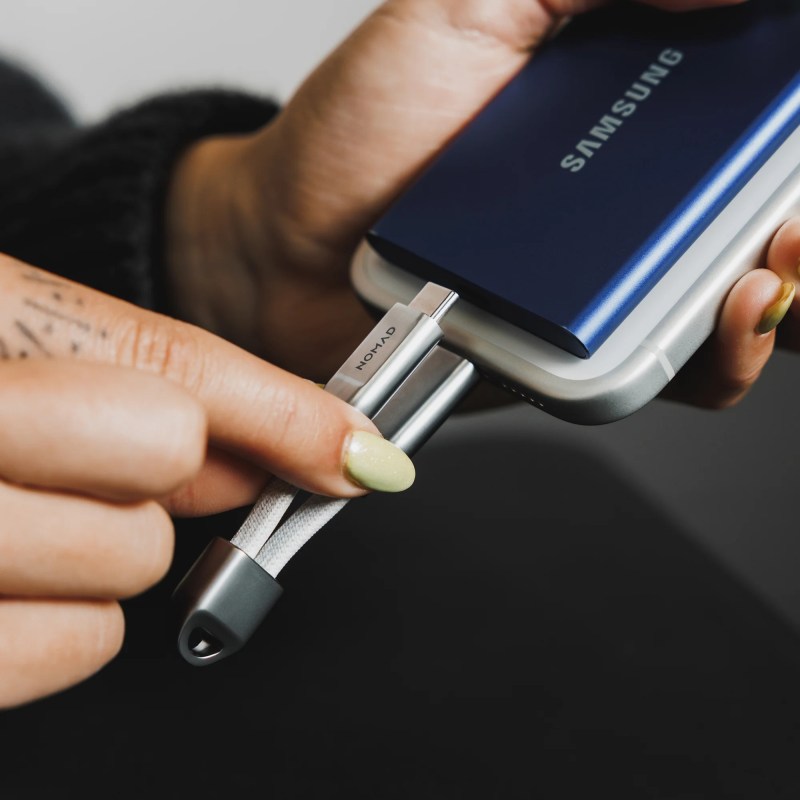 A person holding a usb cable