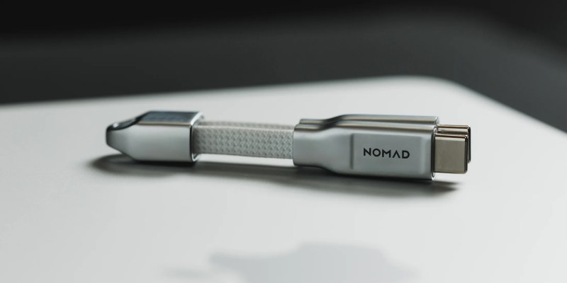 A silver cable with a white strap