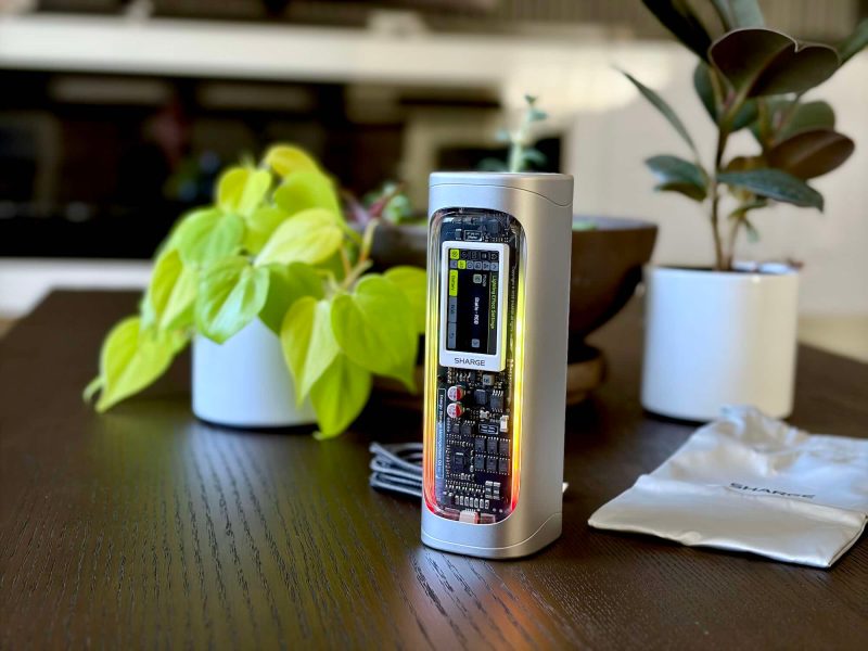 A silver device with a lit up display on a table