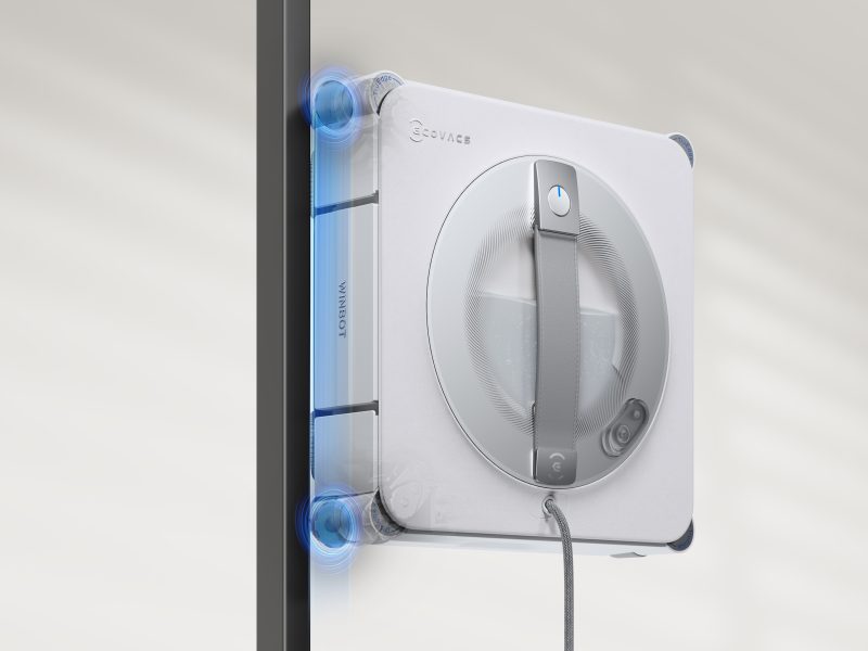 A white rectangular device with a cord attached to a black pole