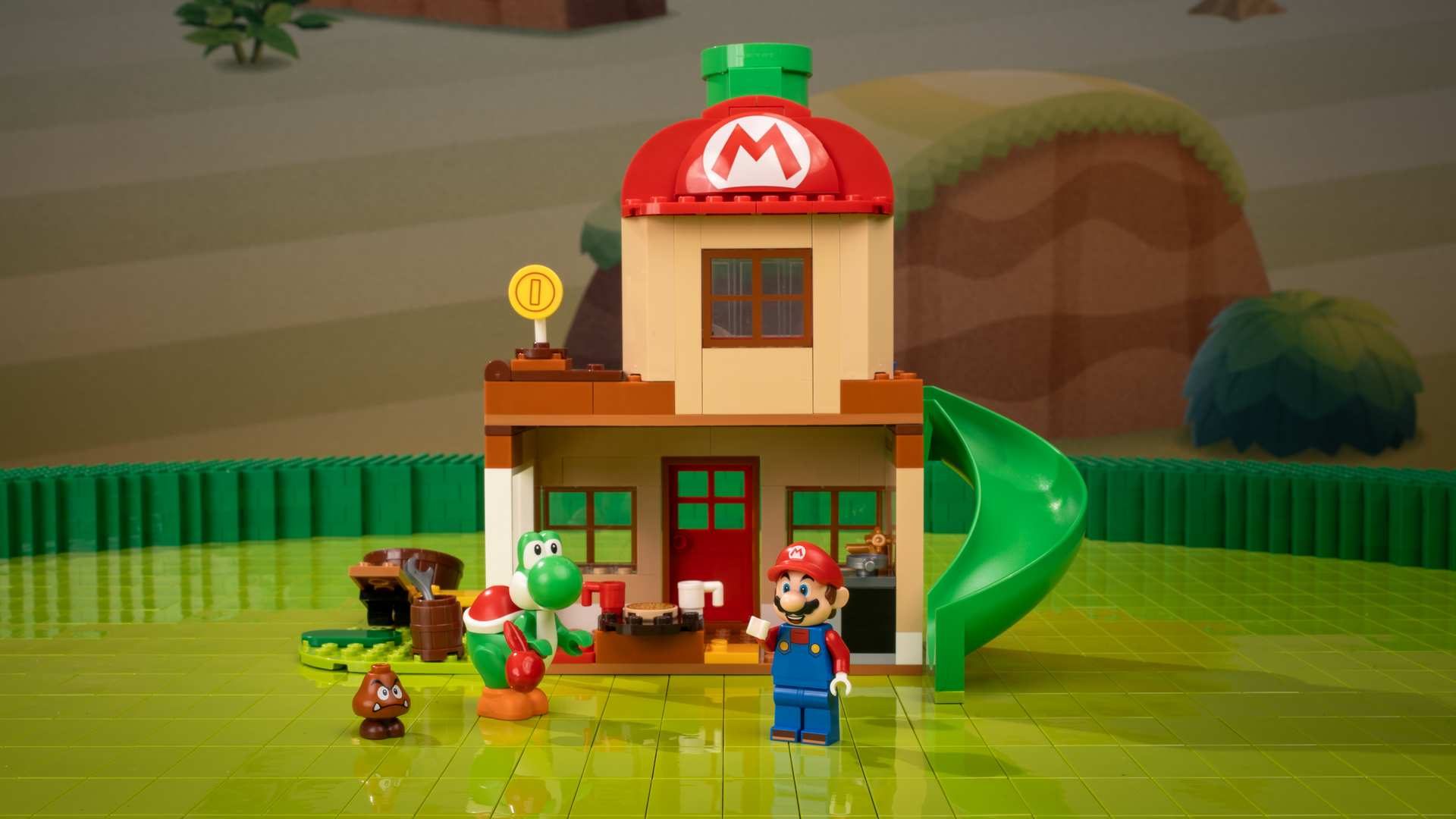 A toy building set with a toy house and a man and a frog