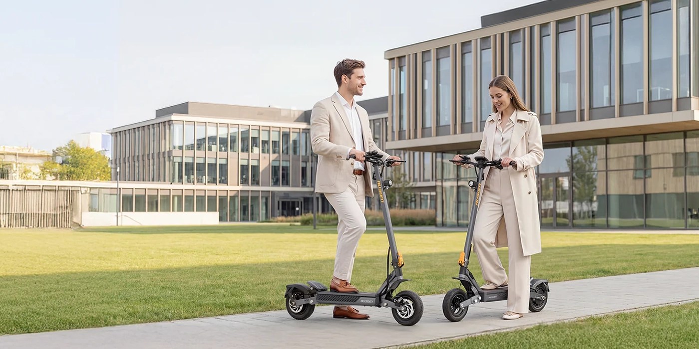 A man and woman standing on scooters