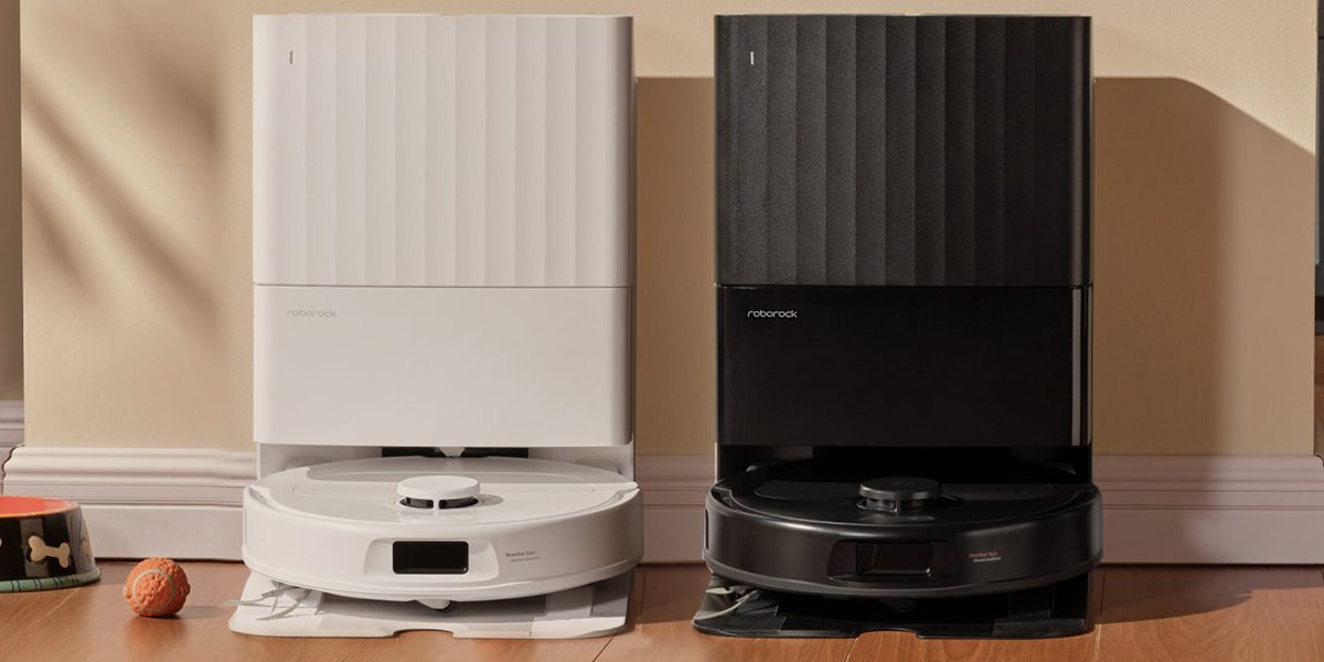 A white and black robot vacuums