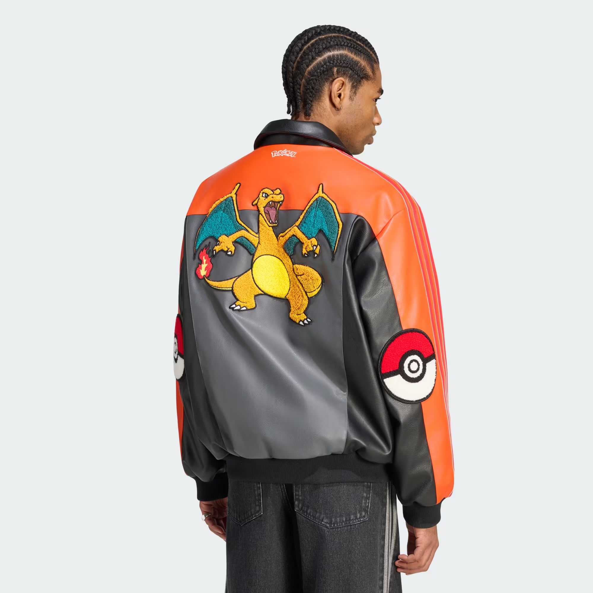 A man wearing a jacket with a cartoon character on it