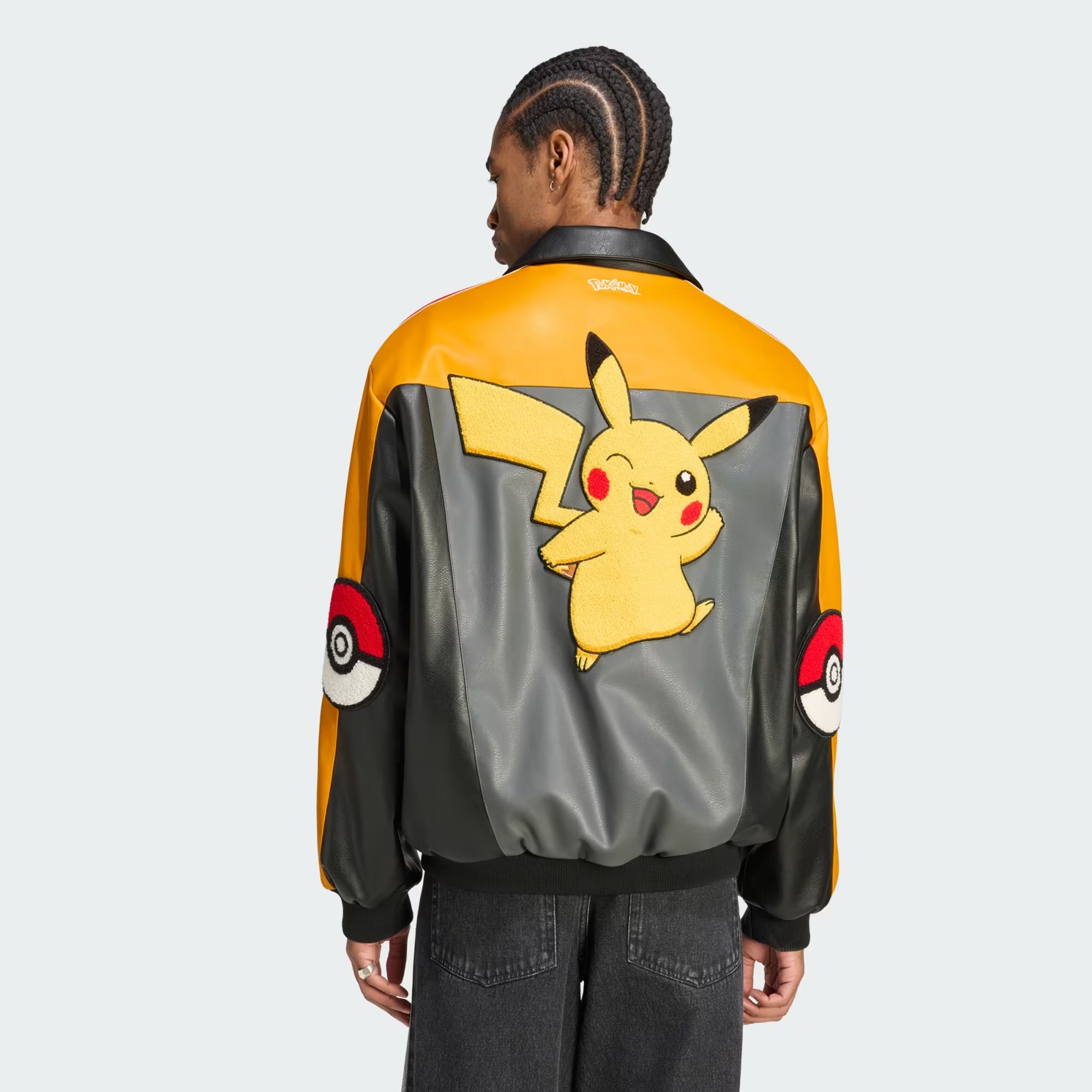 A man wearing a jacket with a cartoon character on it