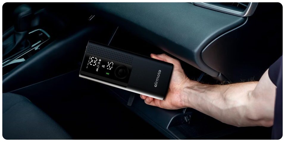 A hand holding a device in a car