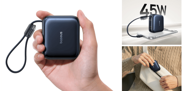 A hand holding a black square object