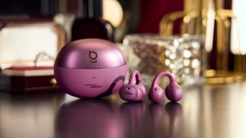 A purple headphones next to a pink container