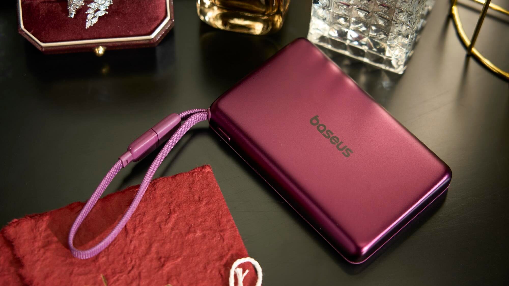 A purple rectangular device with a cord