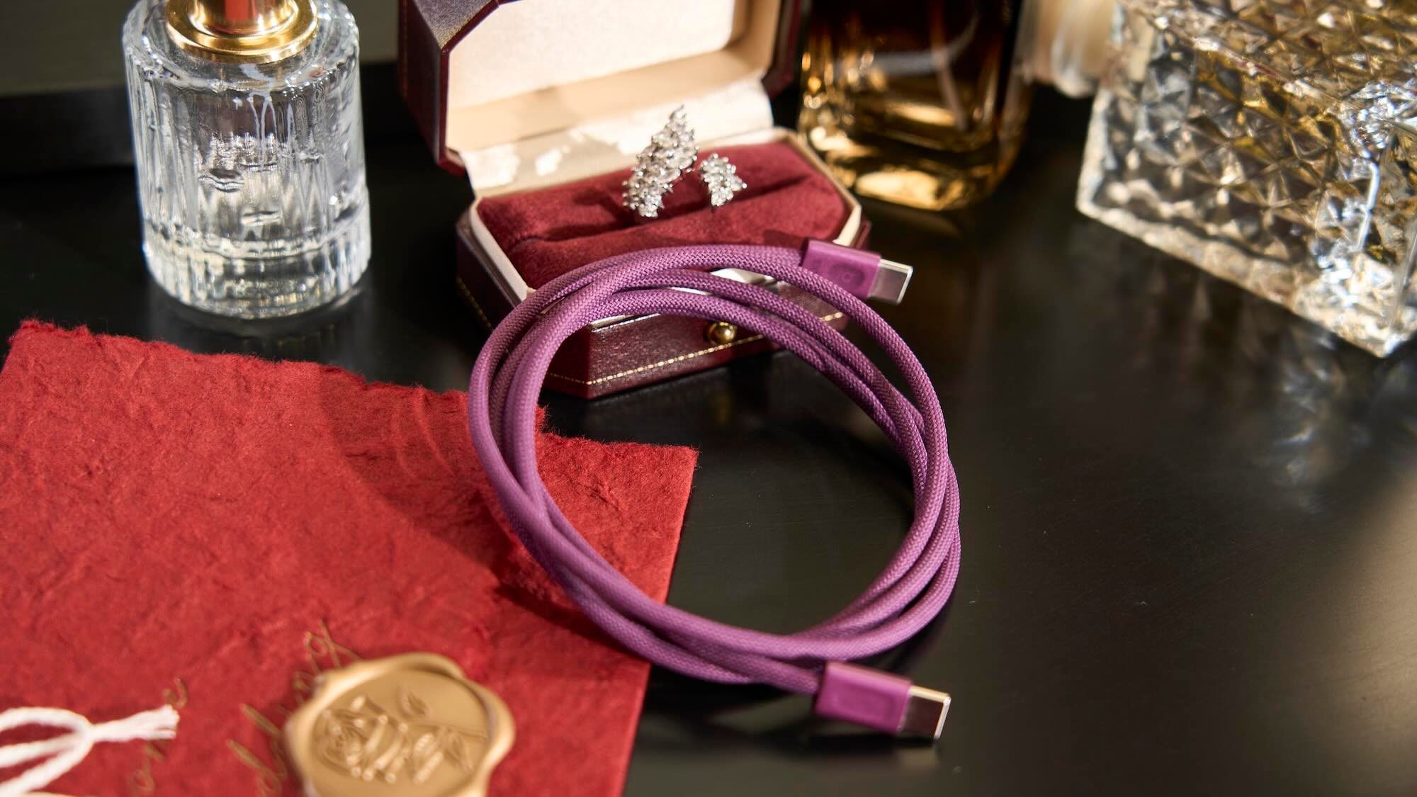 A purple cord and earrings in a box