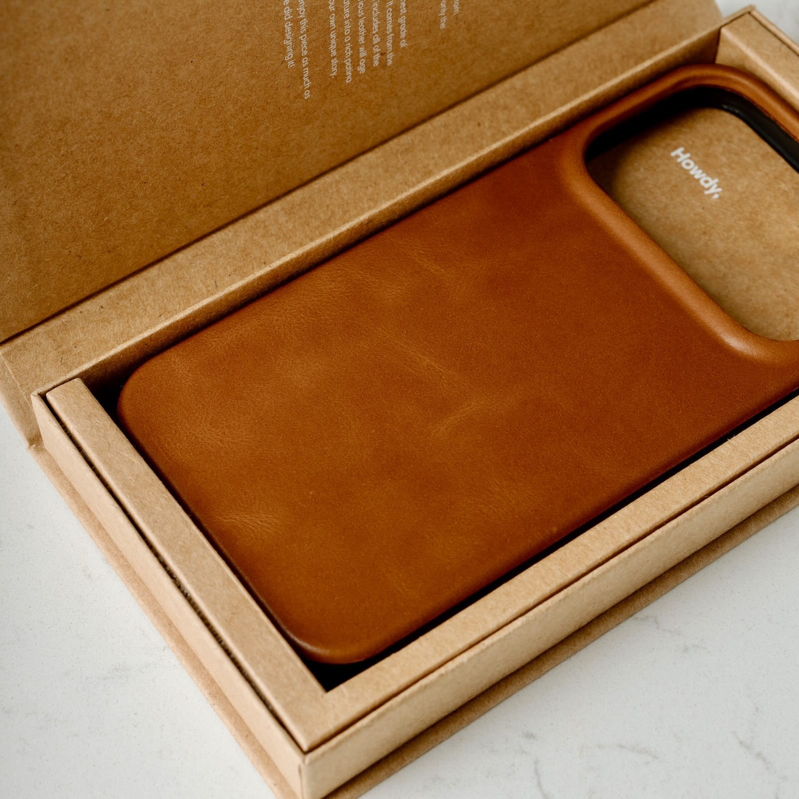 A brown leather case in a box