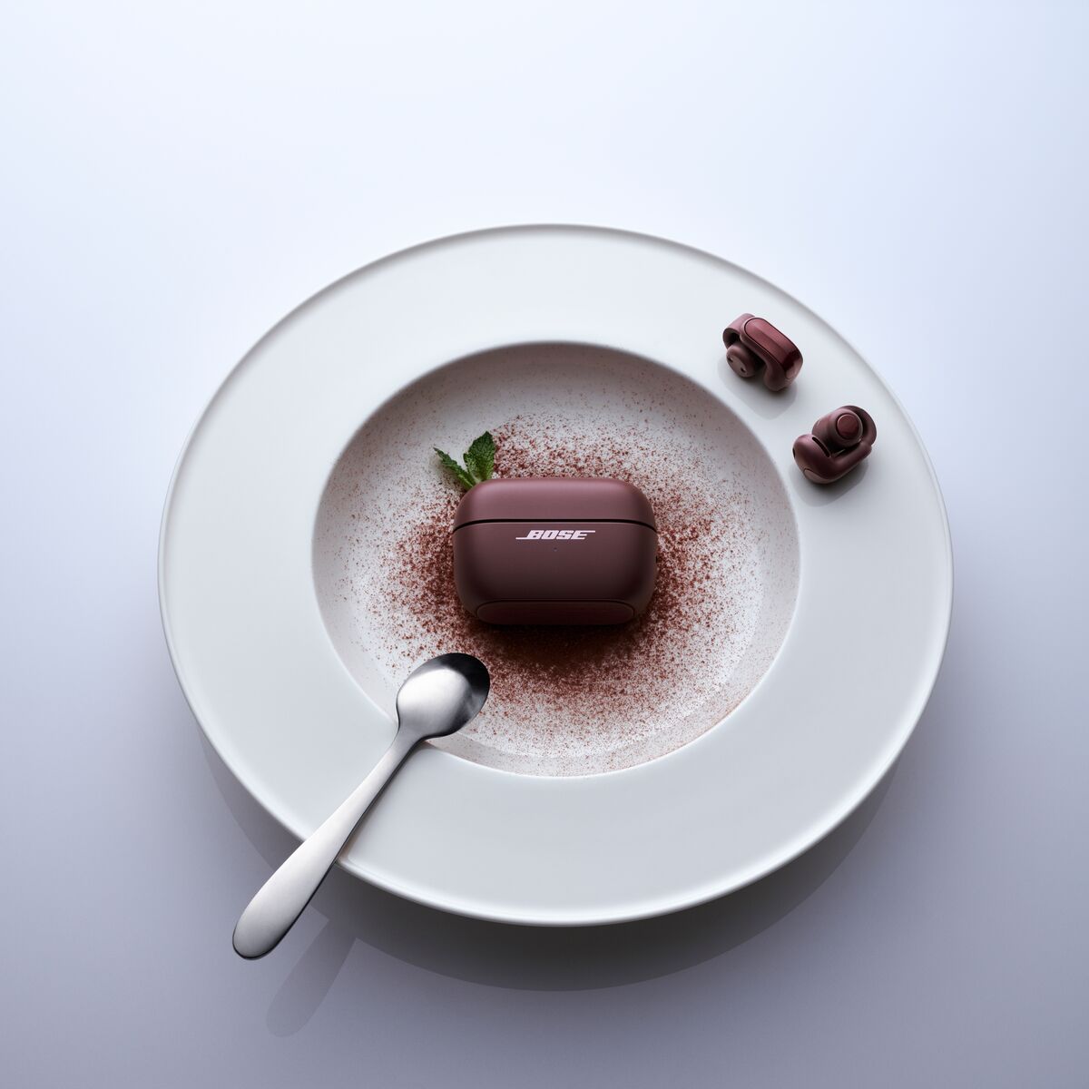A plate with earphones and a brown object on it