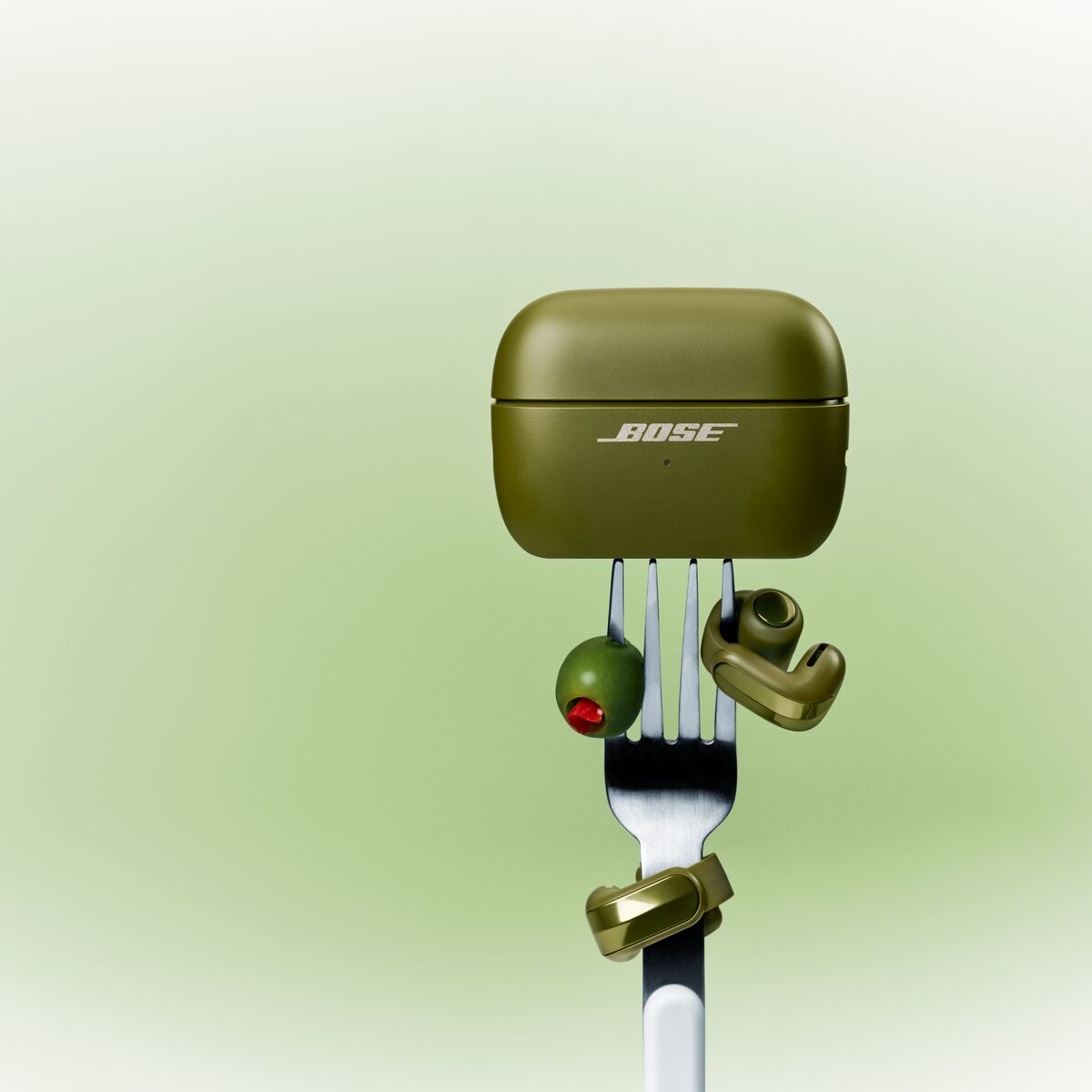 A fork with a green object on it