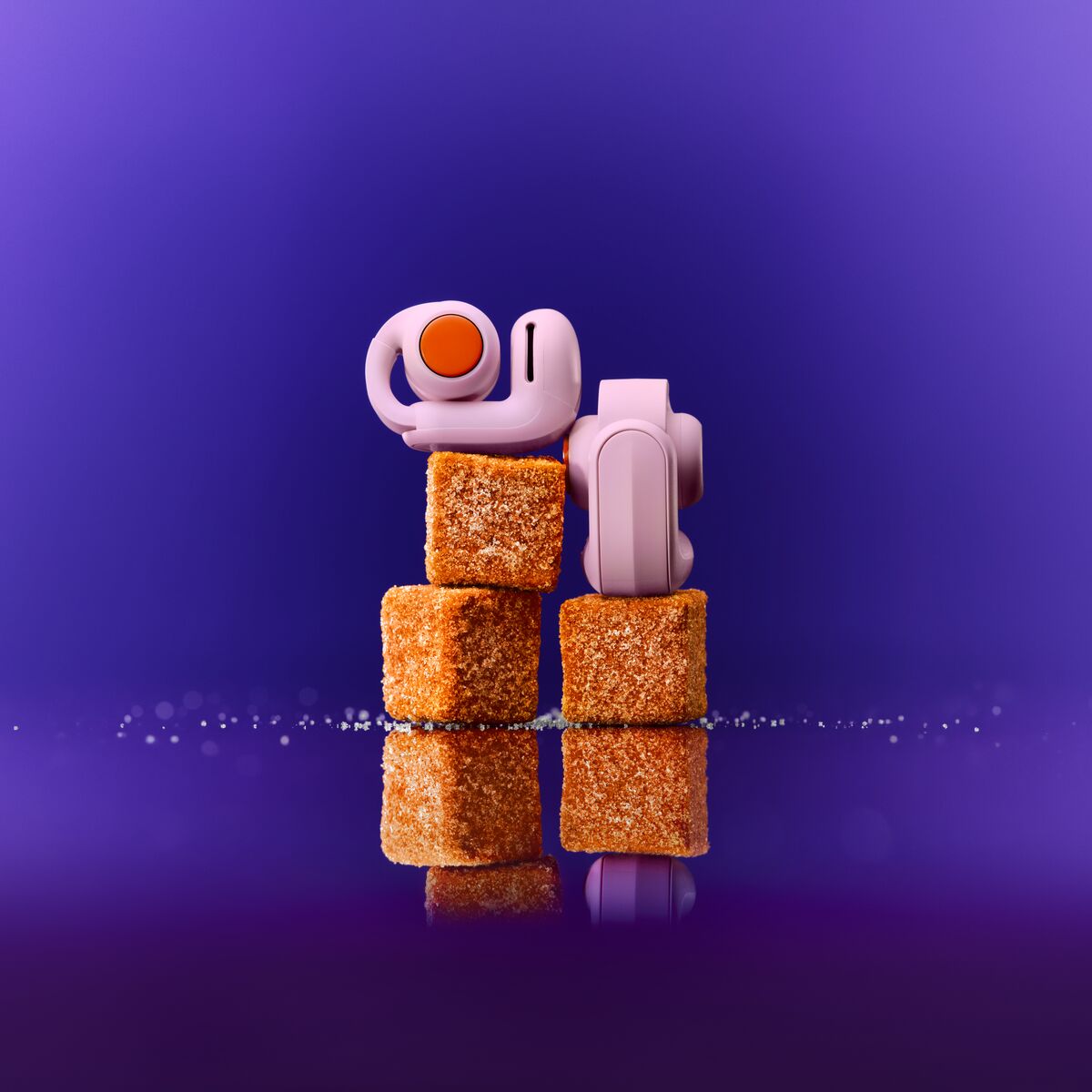A pair of earbuds stacked on top of brown cubes