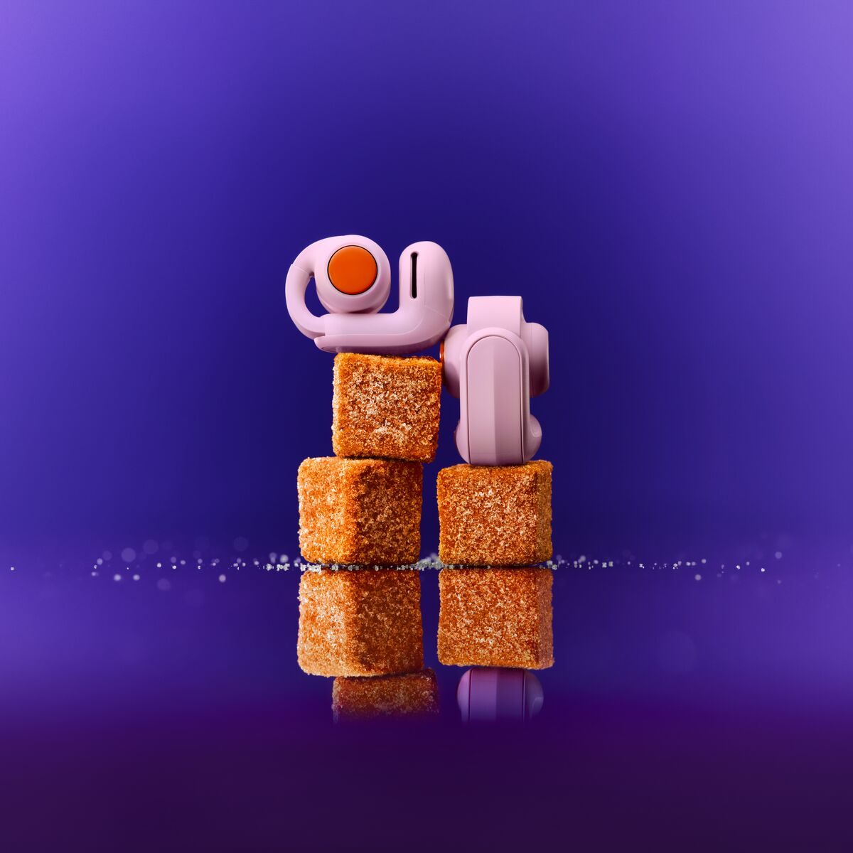 A pair of earbuds stacked on top of brown cubes