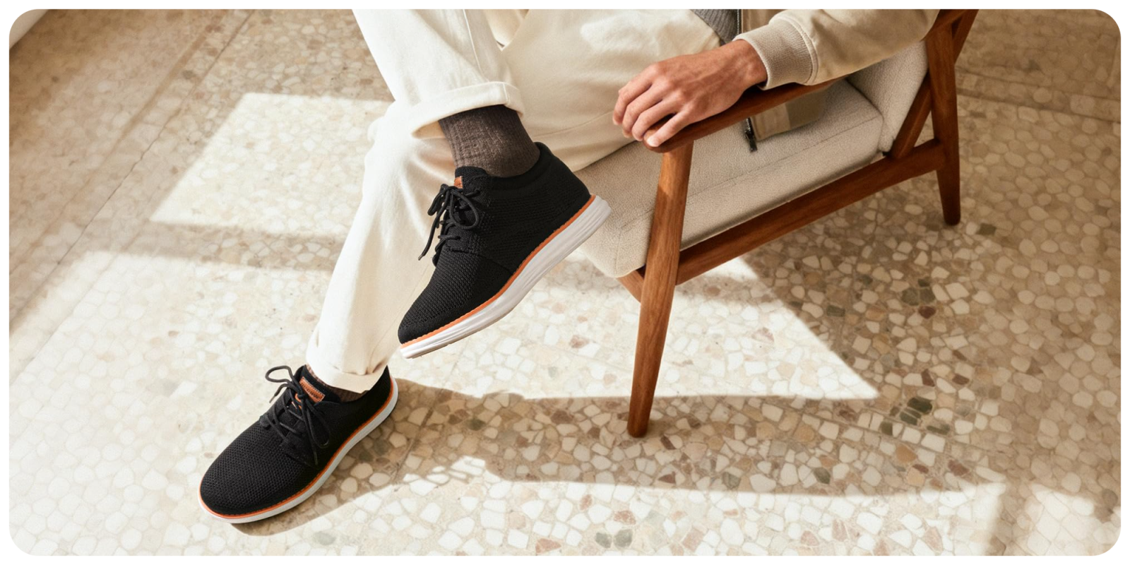 A person wearing black shoes and white pants