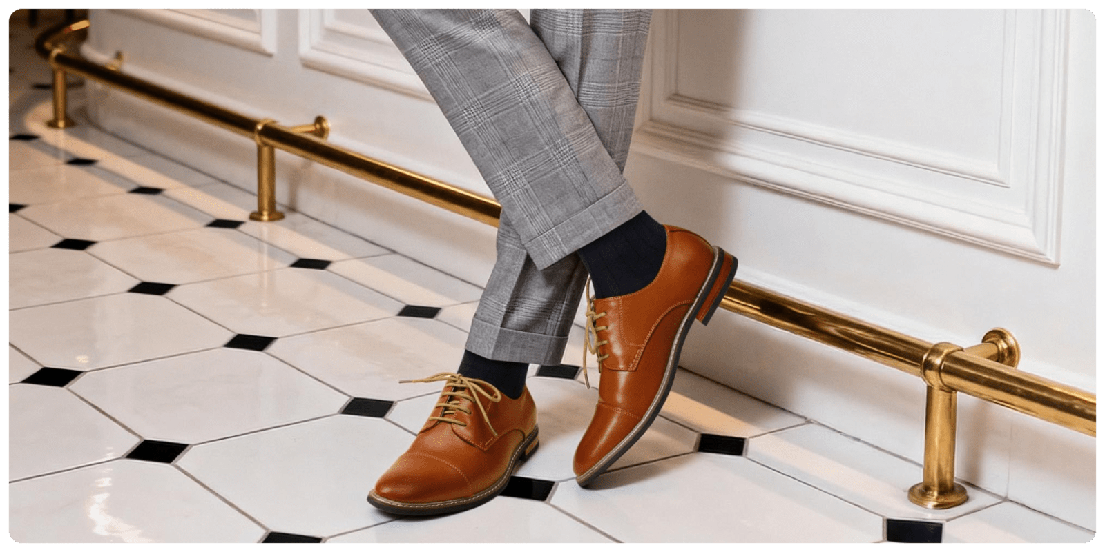 A person's legs wearing brown shoes and grey socks