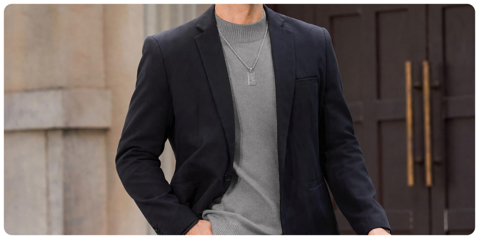 A man wearing a suit and a necklace