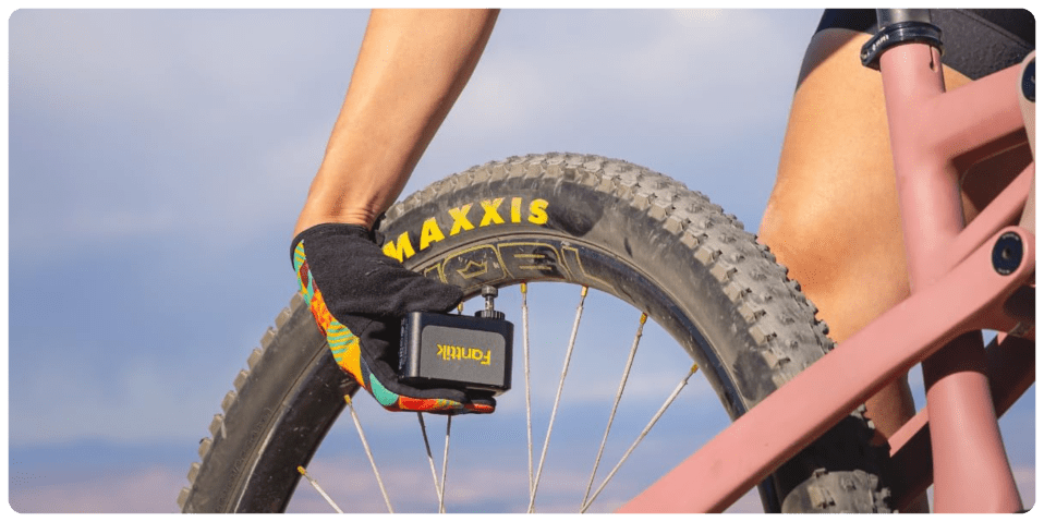 A person's hand holding a bicycle tire