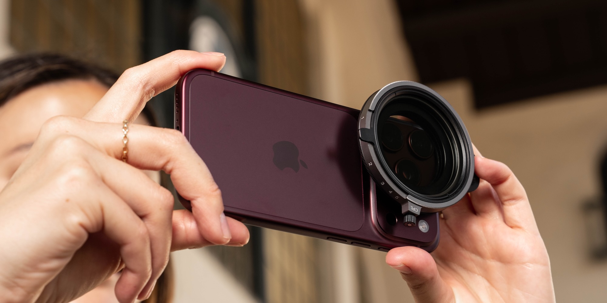 A person holding a camera lens