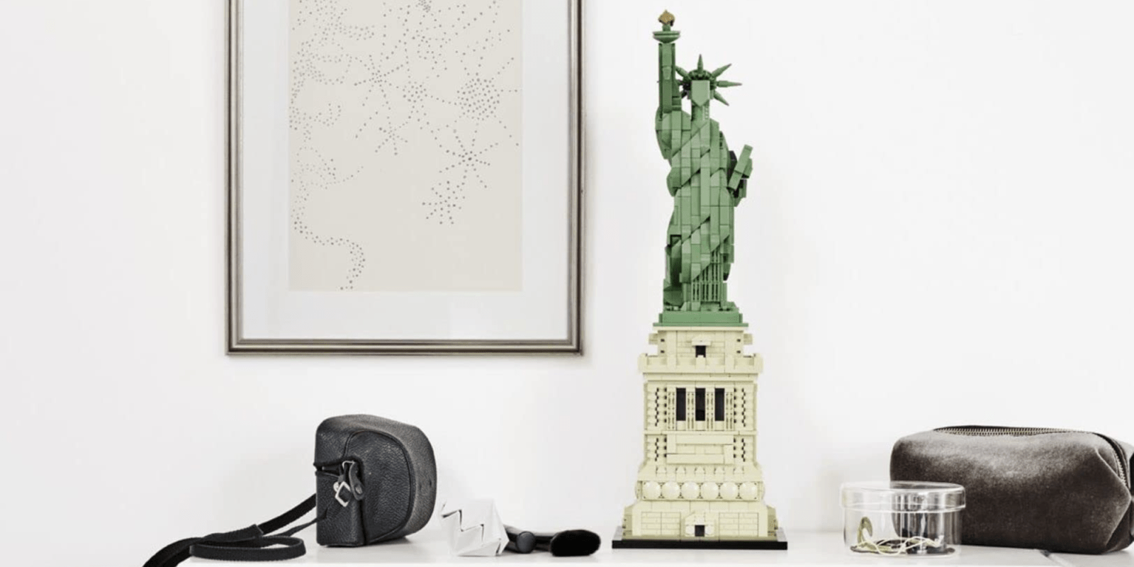 A statue of liberty and a bag on a shelf