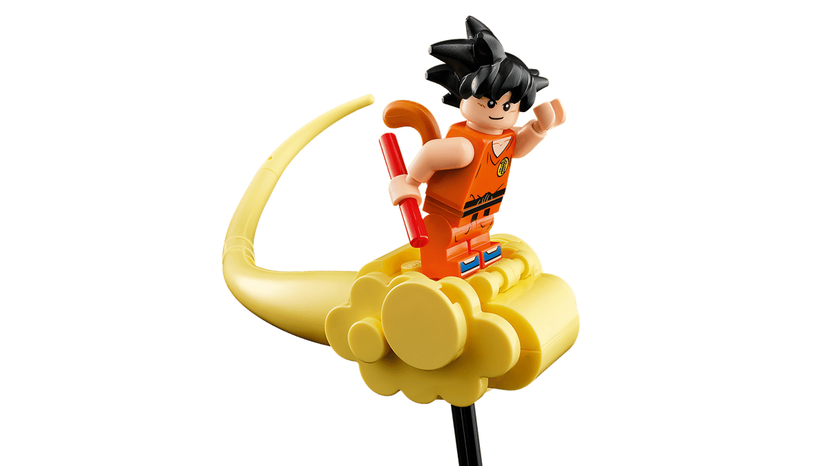 A toy figurine of a man on a yellow object