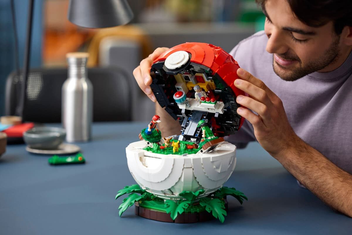 A man looking at a lego model