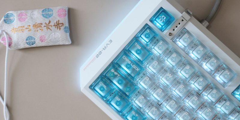 A keyboard with blue buttons and a sock