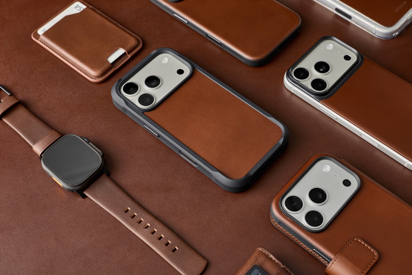 A group of cell phones and a leather case