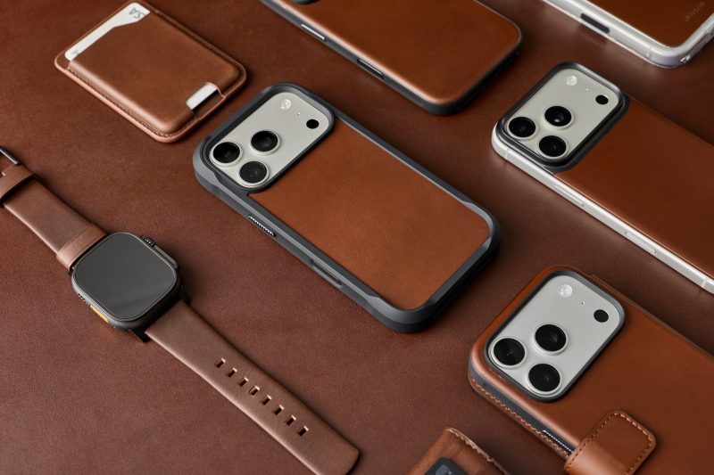 A group of cell phones and a leather case
