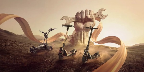 A giant hand holding a wrench and scooters
