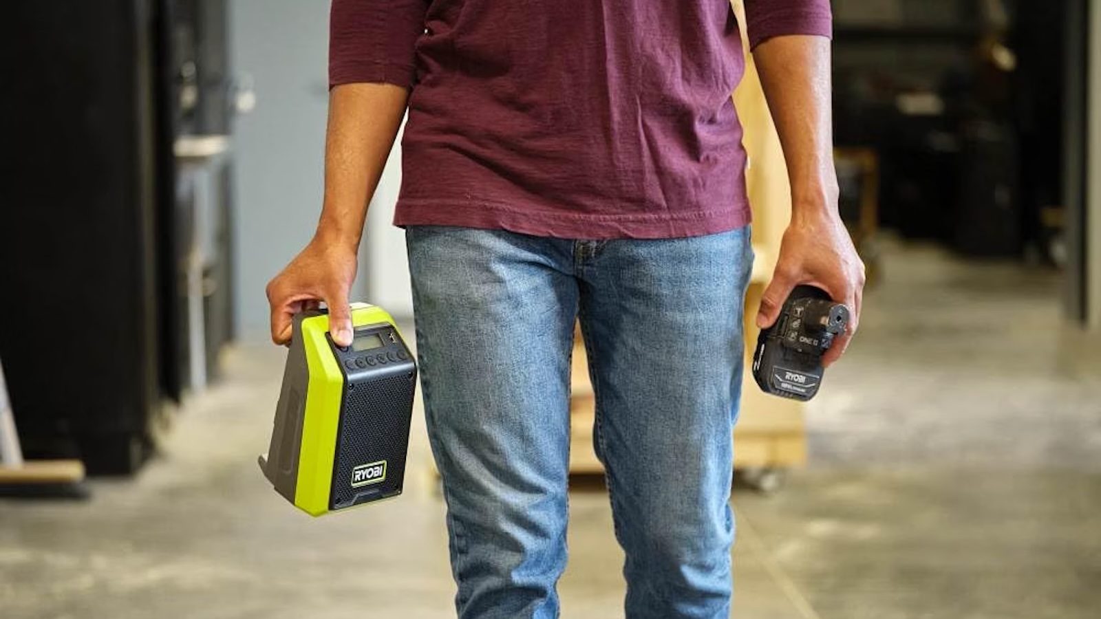 A man holding two batteries