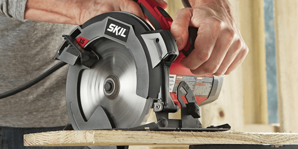 A close-up of a man using a circular saw