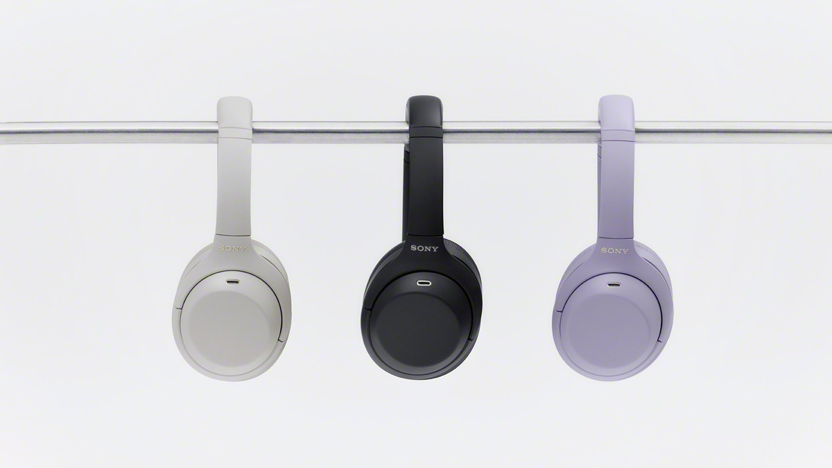 A group of headphones on a metal bar