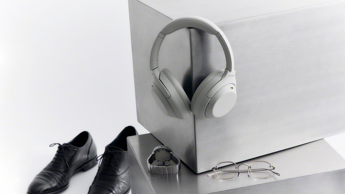 A pair of white headphones on a metal box